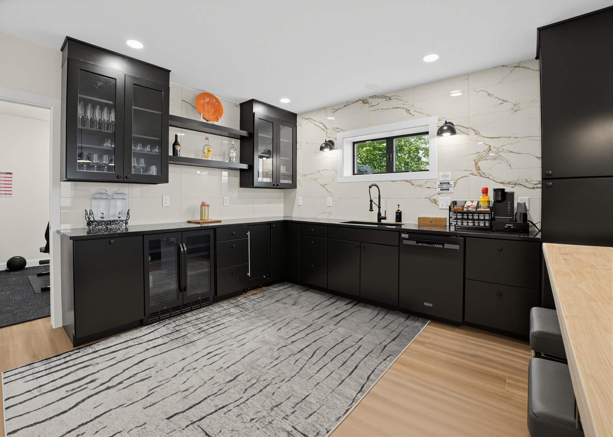 Full bar wall with black cabinets, marble backsplash, and wine fridge