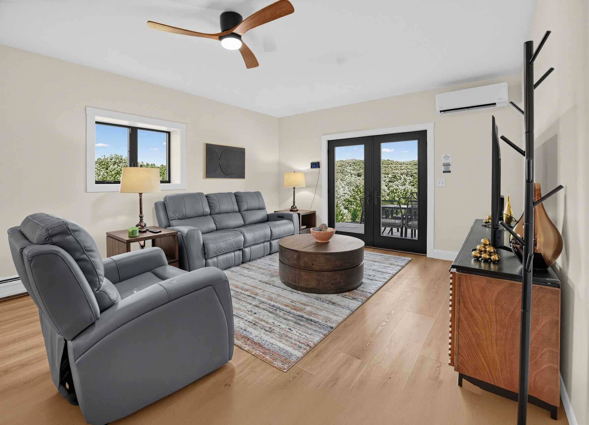 Living area with gray leather recliners and mountain views