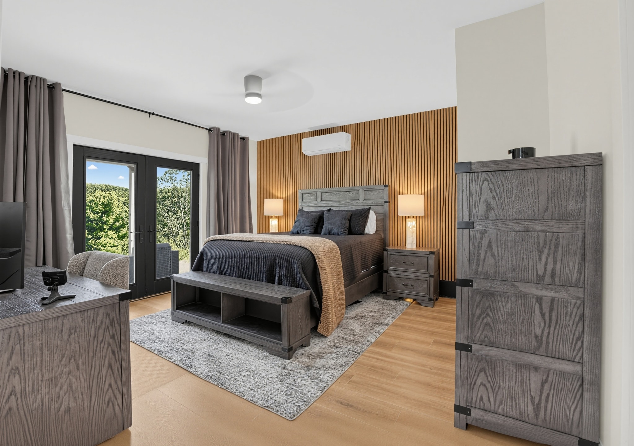 Guest bedroom with wood accent wall and garden doors