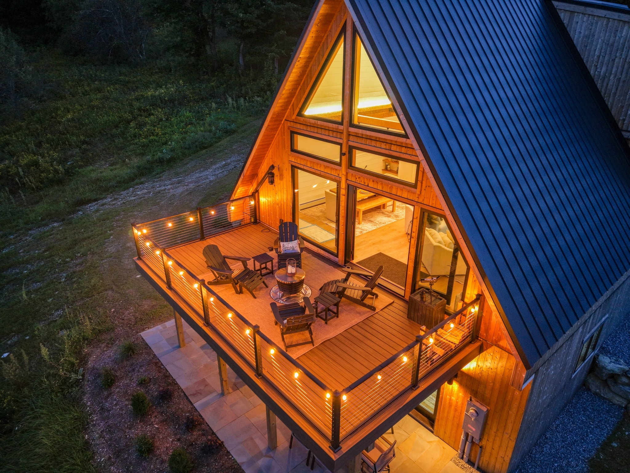 Nest In The Mountains A-frame glowing at dusk
