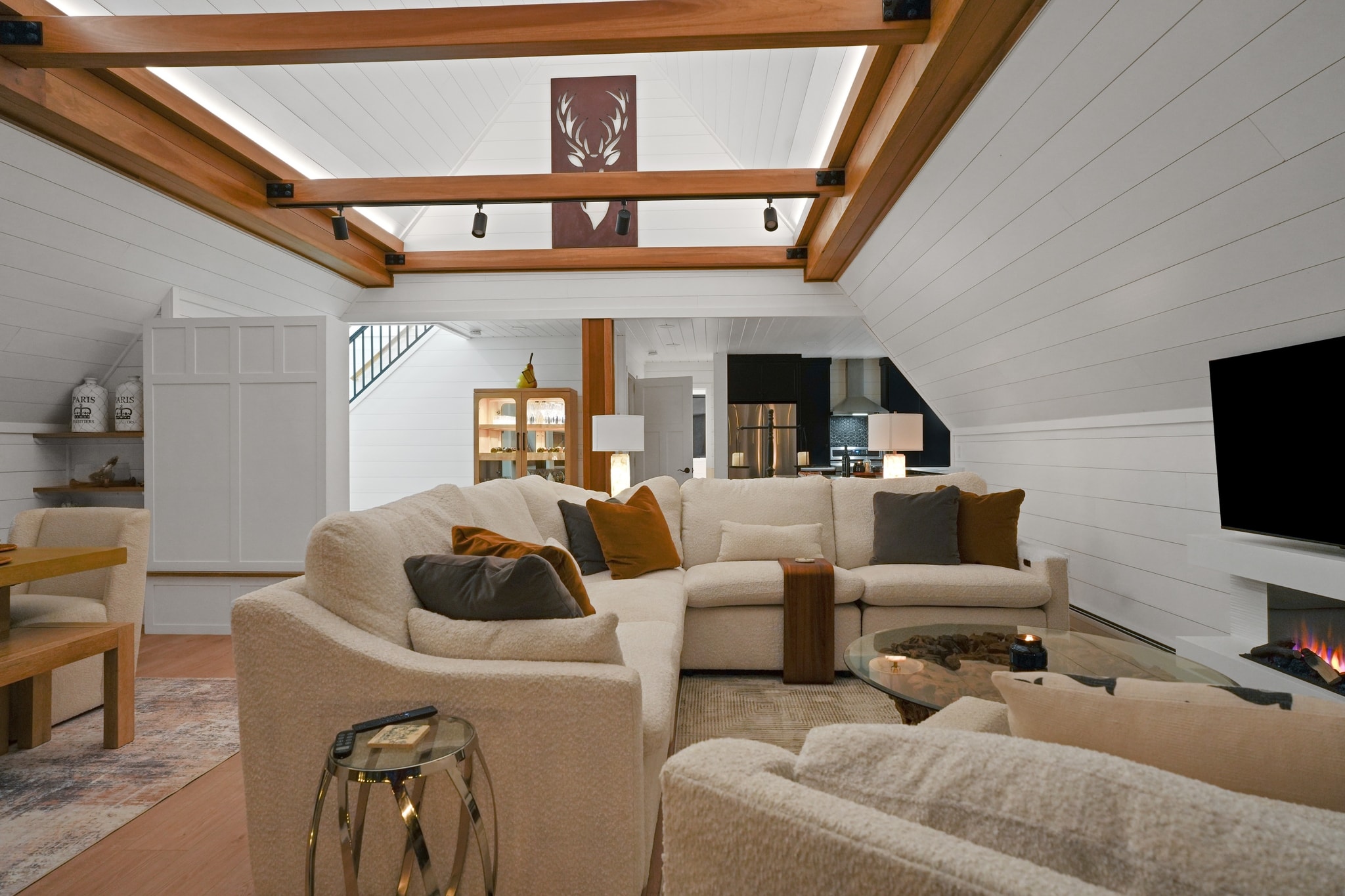 Great room with exposed wood beams and sectional sofa