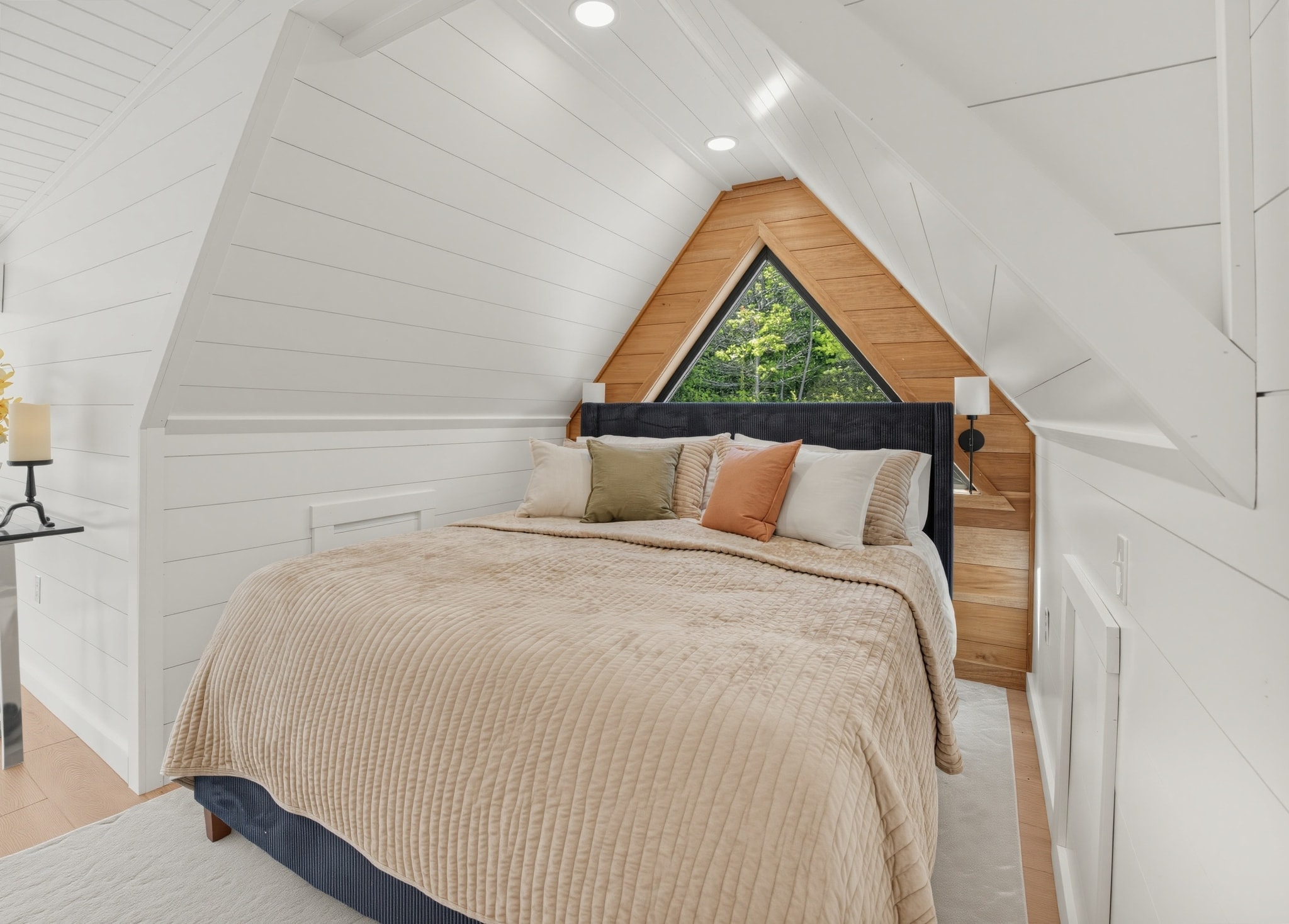 Owner's suite with A-frame triangular window and shiplap walls