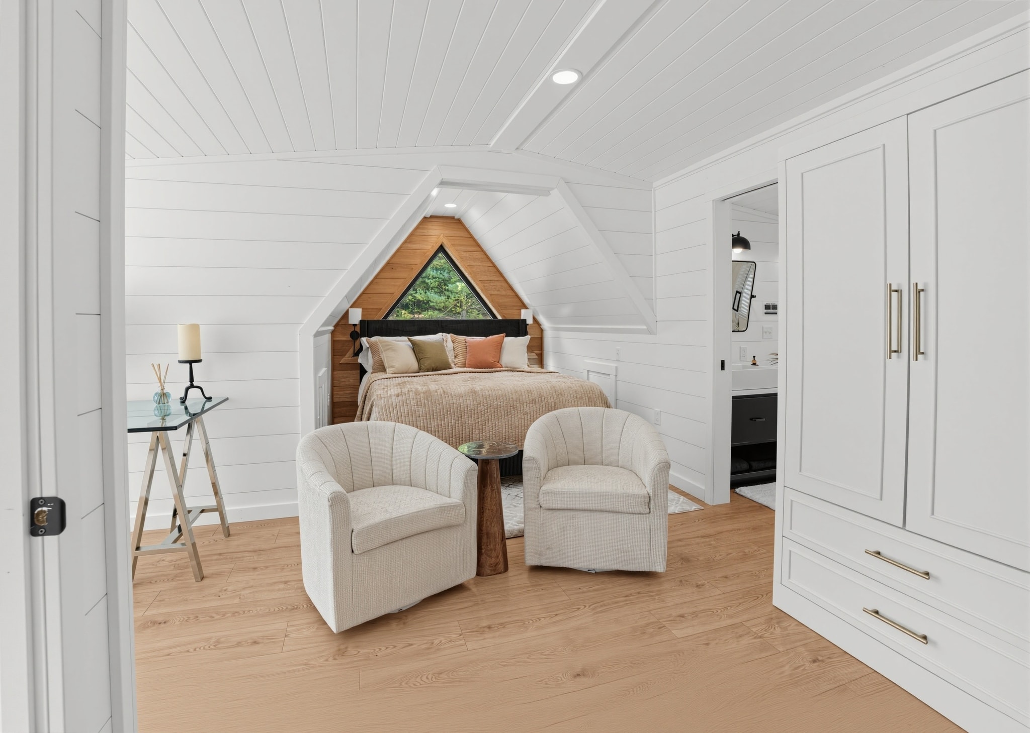 Owner's suite overview with armchairs and wardrobe