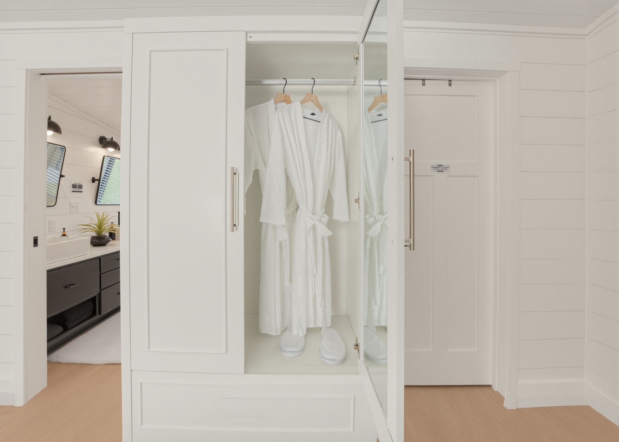 Owner's suite wardrobe with white robes