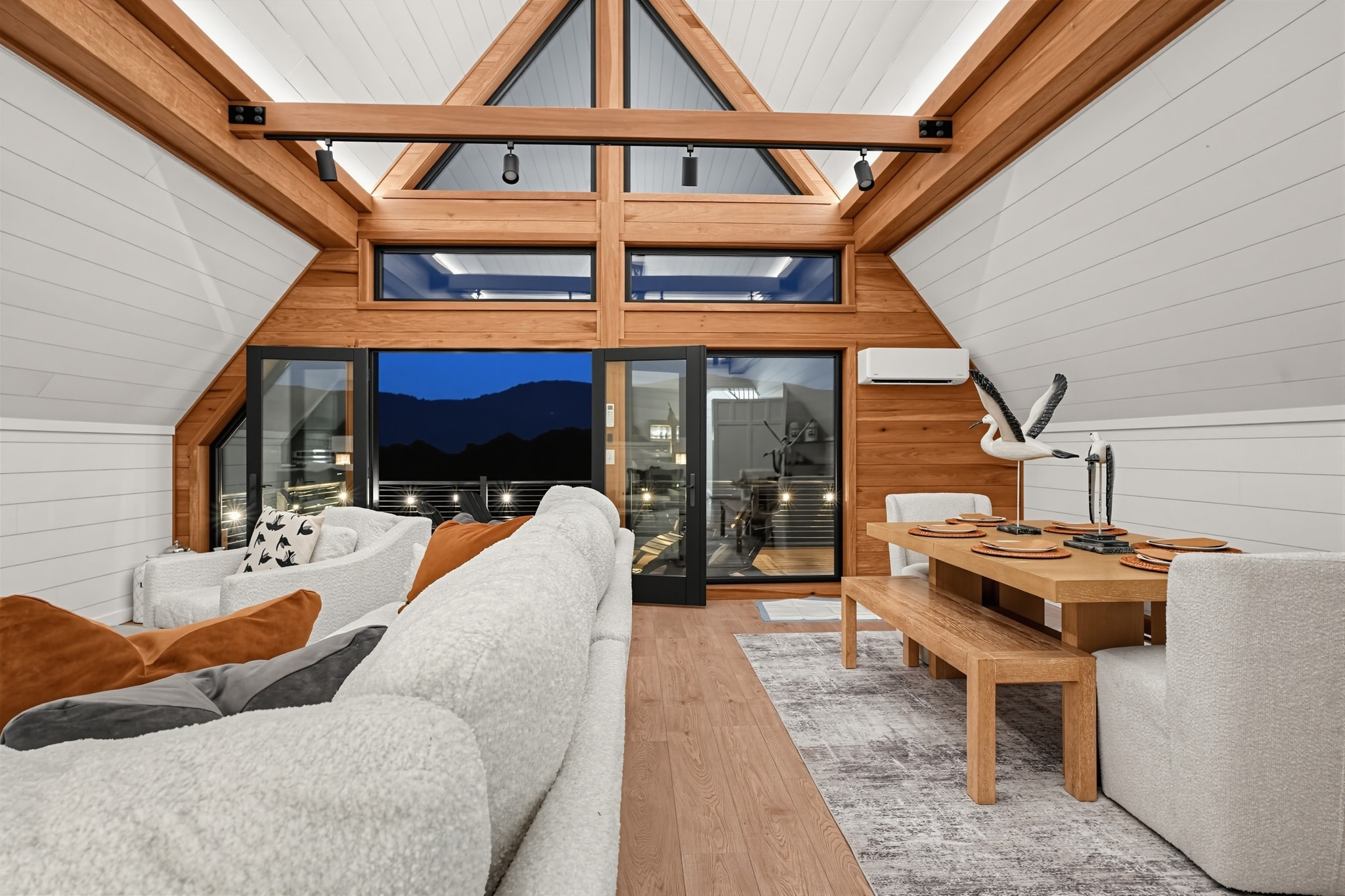 A-frame cabin interior with soaring ceilings and forest views